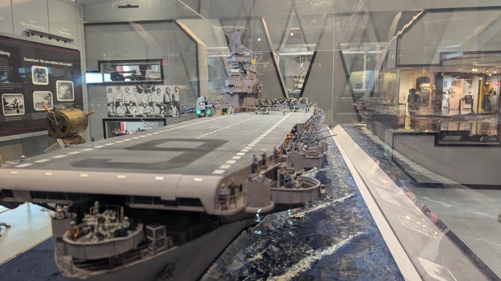 Interior shot of a model of the CV Enterprise, with little figures representing sailor 