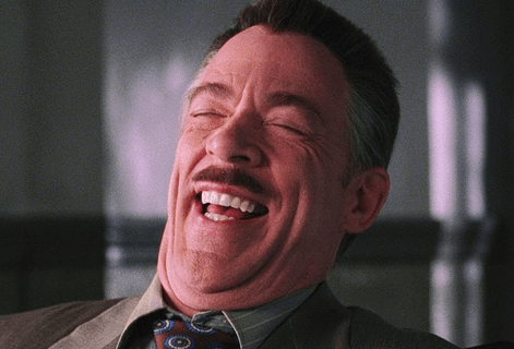A mustached man laughing