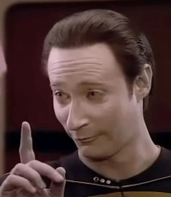 A photo of Commander Data pointing upwards. 